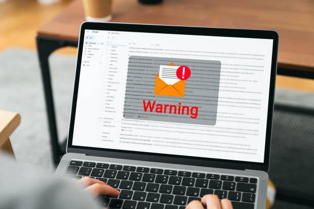 Laptop showing email warning notification on screen